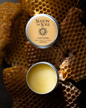 Two tins of 'Season of Soul' vanilla lip balm on a honeycomb background