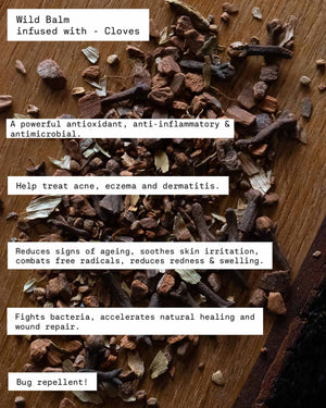 Wild balm infused with cloves on a wooden surface with text about its benefits.
