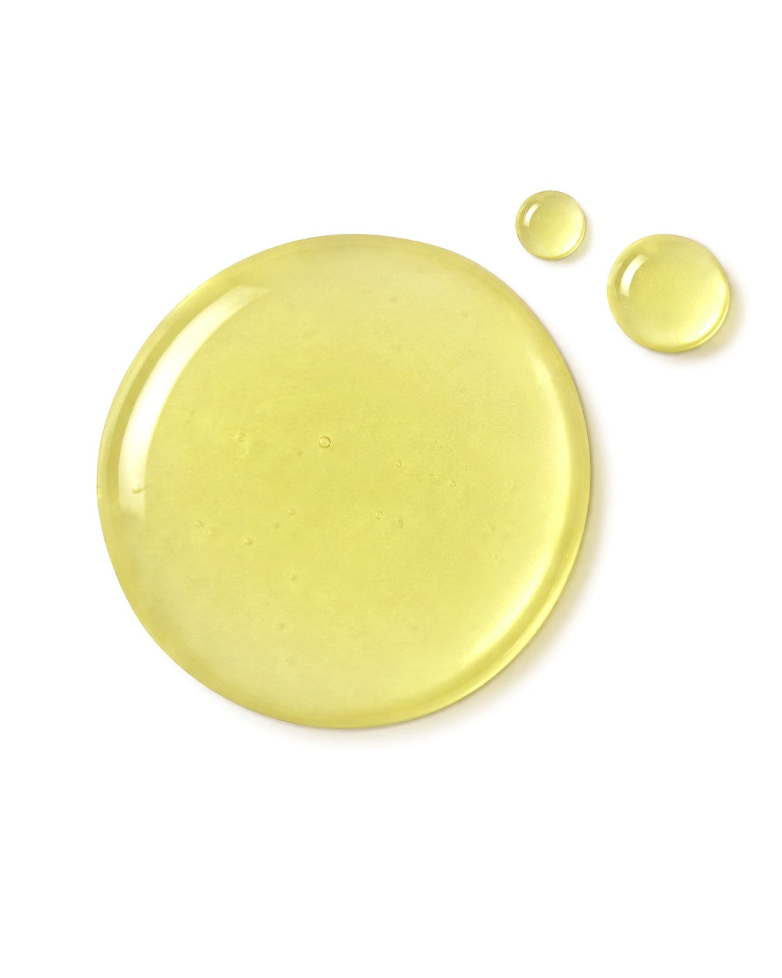 A glossy, translucent droplet of pale yellow cosmetic or liquid product on a solid white background, with two smaller droplets to the upper right of the main droplet.