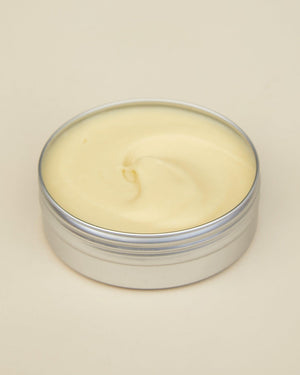 Tin of cream on a beige background