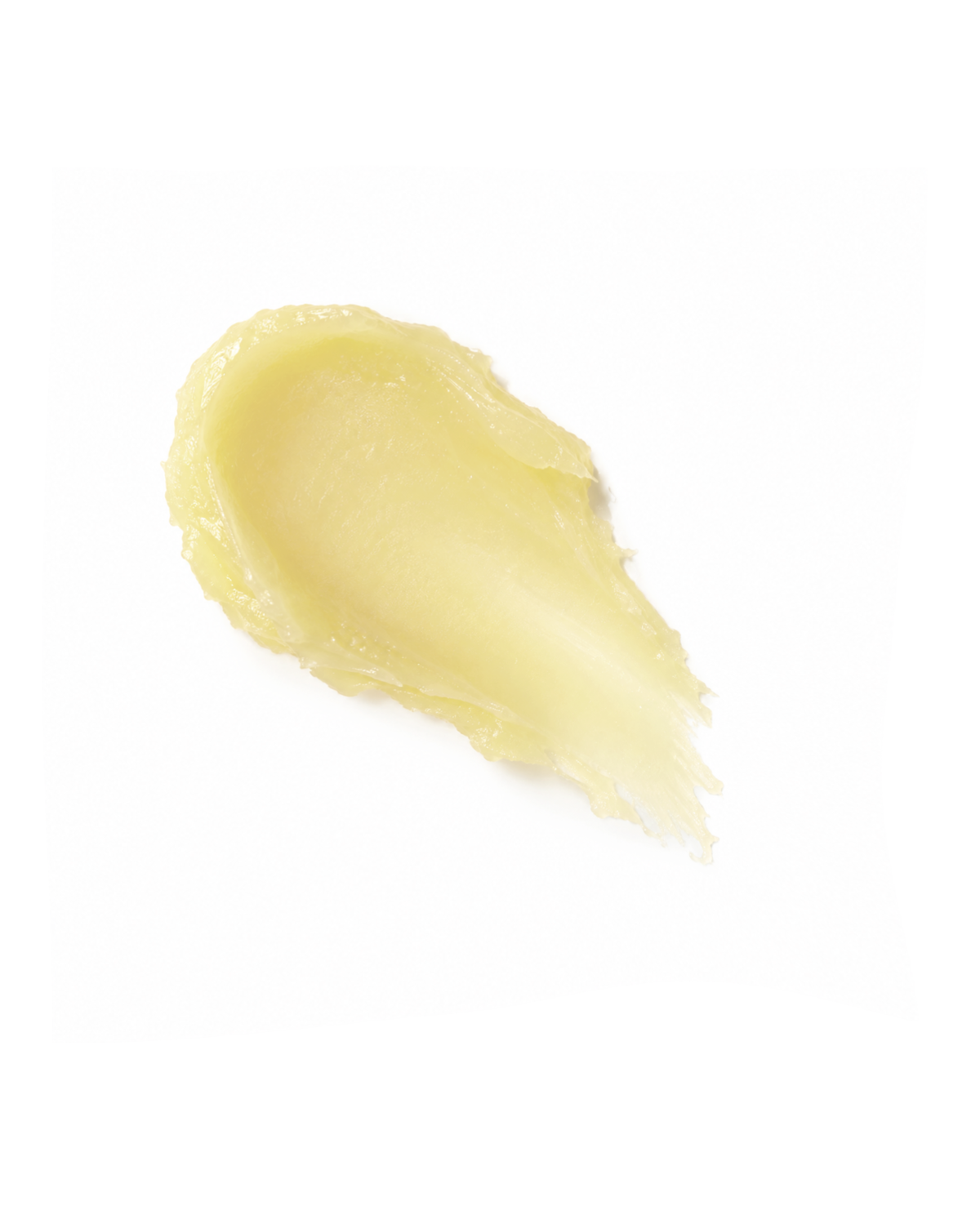 A smear of pale yellow cream or balm on a solid white background.