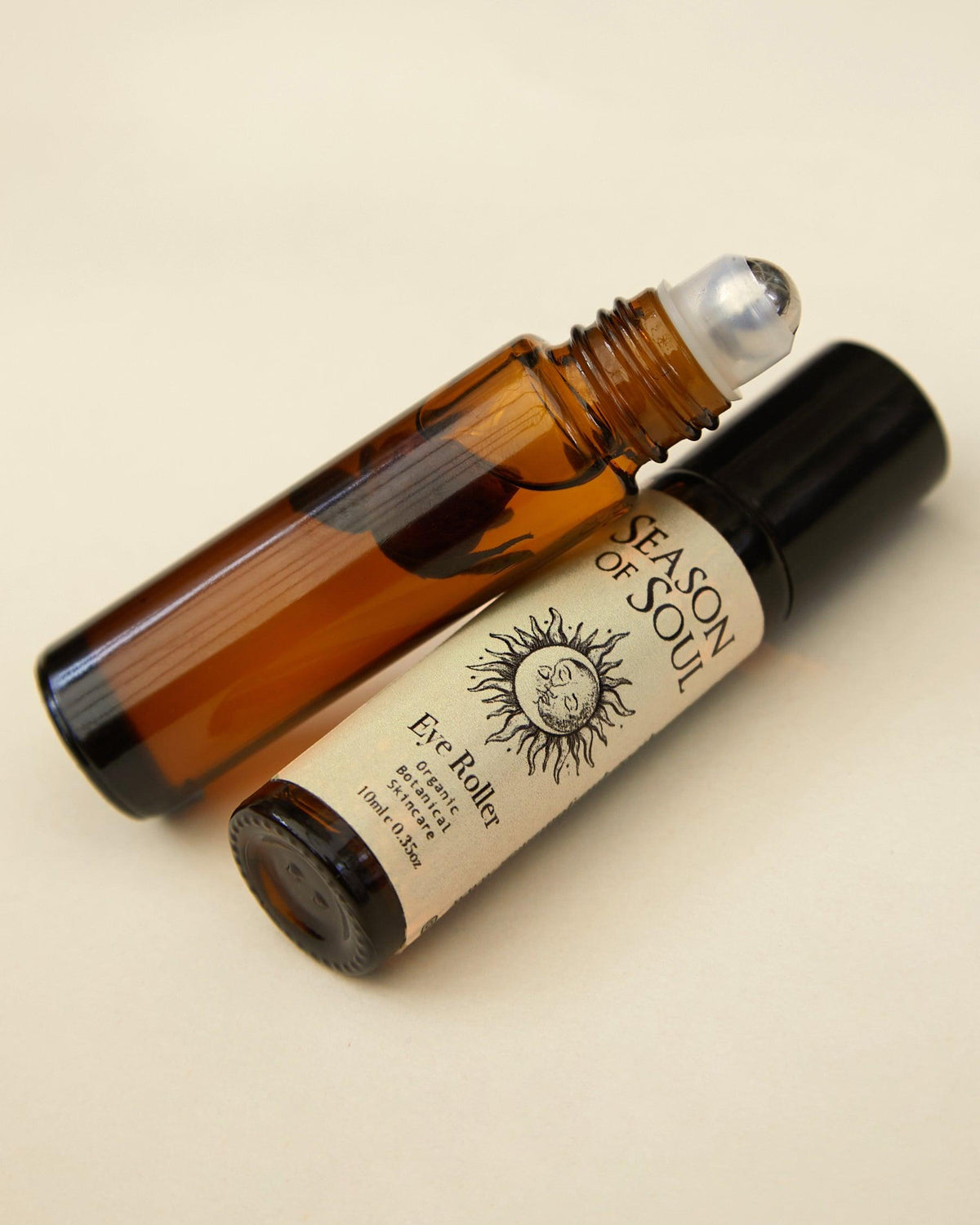 Roll-on bottle with a label on a beige background