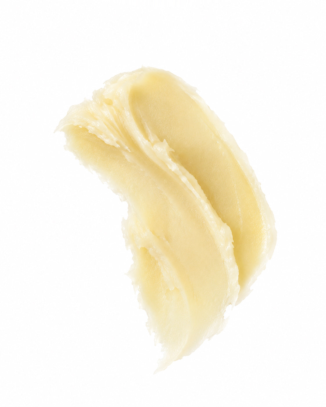 A thick, creamy pale yellow tallow balm with a smooth, swirled texture, isolated on a solid white background.