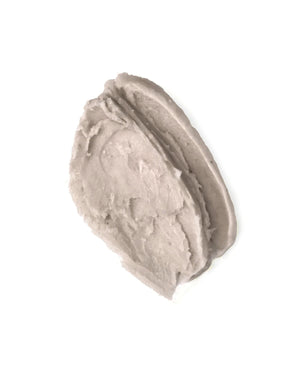 A thick, textured smear of light gray cream or balm on a solid white background.